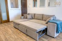a living room with a couch and a table at Bright &amp; cosy 3BR home with private balcony &amp; WIFI by 360 Estates in Dingli