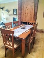 a dining room table and chairs with a wooden table and a table at Casa Las Lomas in Prado del Rey