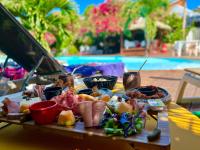 a tray of food on a table next to a pool at Tropicana Suites in Deshaies