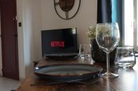 a wooden table with two wine glasses and a plate on it at Appartement centre ville de Pierrelatte&#39; in Pierrelatte