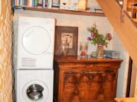 a laundry room with a washing machine and a wooden table at Gîte Loches, 2 pièces, 6 personnes - FR-1-381-268 in Loches