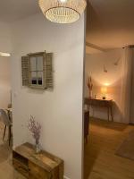 a living room with a table and a window at Charmant T3 à côté des Thermes in Luxeuil-les-Bains