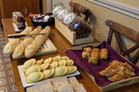 a table with various types of bread and pastries at Contact Hôtel du Commerce et son restaurant Côte à Côte in Autun
