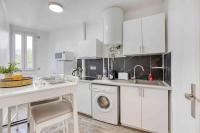 a kitchen with white cabinets and a washing machine at Appartement chic proche gare de Clamart + Netflix in Malakoff
