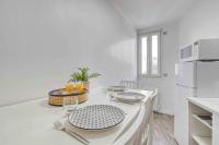 a white kitchen with plates and glasses on a counter at Appartement chic proche gare de Clamart + Netflix in Malakoff