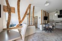 a kitchen and living room with wooden beams on the wall at Plain pied avec terrasse à 5 minutes de Berck in Verton