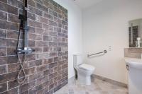 a bathroom with a toilet and a sink at Plain pied avec terrasse à 5 minutes de Berck in Verton