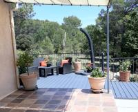 an outdoor deck with furniture and potted plants at BELLA VISTA 1 chambre d&#39;hôtes 2 personnes in Salernes