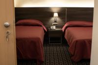 Posteľ alebo postele v izbe v ubytovaní Gemelli Hotel