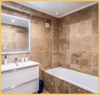 a bathroom with a tub and a sink at Appart T3 Luxe Douvaine in Douvaine