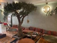 a living room with a couch and a tree at Riad SPA &quot;Les Portes de l&#39;Orient&quot; TOURS in Tours