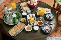 a table with breakfast foods and drinks on it at Riad SPA &quot;Les Portes de l&#39;Orient&quot; TOURS in Tours