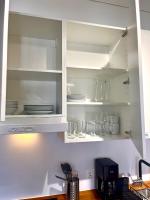 a kitchen cabinet with plates and glasses in it at LUXUS sApartments in der Kunstvilla &amp; kostenloses parken in Premstätten