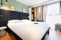 a bedroom with a large white bed in a room at ibis Paris Bastille Faubourg St Antoine in Paris