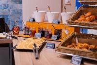 a buffet with various types of food on a table at Best Western Hotel De La Plage Saint Marc sur Mer in Saint-Nazaire