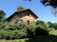 a large wooden house in the middle of a field at Modern apartment in Soultzeren in Soultzeren