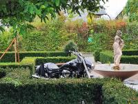 a motorcycle laying on the ground next to a statue at LUXUS sApartments in der Kunstvilla &amp; kostenloses parken in Premstätten