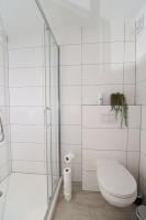 a white bathroom with a toilet and a shower at Louisappart - Eupen Zentrum in Eupen