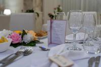 a table with wine glasses and a menu on it at Mg Palace Hotel Costa del Sole in Vaccarizzo - Delfino
