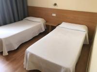 Postel nebo postele na pokoji v ubytování Hotel Millan