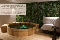 a hot tub in a room next to a chair at Atypik Hotel in Clichy