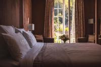 a bedroom with a bed with a large window at 6717 Nature Hôtel &amp; Spa Le Clos des Délices in Ottrott