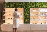 a woman standing in front of a green wall at 6717 Nature Hôtel &amp; Spa Le Clos des Délices in Ottrott
