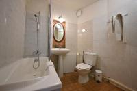 a bathroom with a sink and a toilet and a bath tub at Hotel Esmeralda in Paris