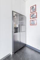a large stainless steel refrigerator in a room at Wonderful luxury house at 10min from Paris in Meudon