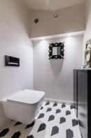 a bathroom with a toilet and a black and white floor at Wonderful luxury house at 10min from Paris in Meudon
