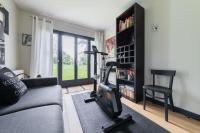 a living room with a couch and a gym at Wonderful luxury house at 10min from Paris in Meudon