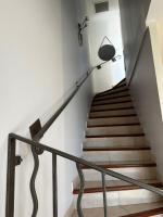 a staircase with a metal railing in a building at Marina Ivoire in Aigues-Mortes