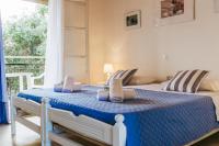 A bed or beds in a room at Sunflower Apartments & Studios