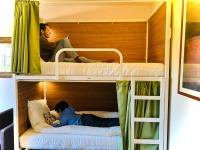 two people sitting on top of a bunk bed at Naéco Erdeven in Erdeven