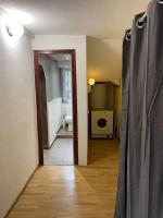 a hallway with a bathroom with a toilet and a sink at Appartement à Uriage les Bains. in Vaulnaveys-le-Haut