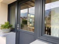 a gray door with a window on a house at Appartement à Uriage les Bains. in Vaulnaveys-le-Haut