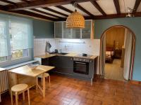 a kitchen with a table and a table and a dining room at Appartement à Uriage les Bains. in Vaulnaveys-le-Haut