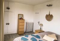 a bedroom with a bed and a dresser at Confort Parisien - parking gratuit - Chaleureux in Rueil-Malmaison