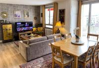 a living room with a couch and a table at Confort Parisien - parking gratuit - Chaleureux in Rueil-Malmaison