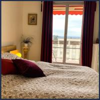 a bedroom with a bed and a large window at Confort Parisien - parking gratuit - Chaleureux in Rueil-Malmaison