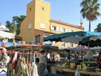 a market with a building with a clock tower at Appartement Les Issambres, 2 pièces, 4 personnes - FR-1-226-540 in La Garonnette-Plage