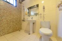 a bathroom with a toilet and a sink and a phone at 晶藍色美人魚 Mermaid Inn in Hualien City
