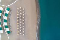 an overhead view of a beach with a bunch of umbrellas at Concorde De Luxe Resort - Prive Ultra All Inclusive in Lara