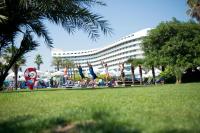 a group of people doing yoga in front of a hotel at Concorde De Luxe Resort - Prive Ultra All Inclusive in Lara