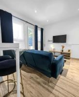 a living room with a blue couch and a bed at Perle de la Loire in Blois