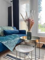 a living room with a blue couch and a table at Perle de la Loire in Blois