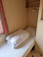 a small bed in a small room at Camping Mayet-de-Montagne in Le Mayet-de-Montagne