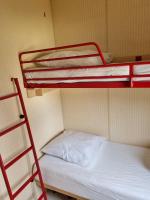 a room with two bunk beds and a ladder at Camping Mayet-de-Montagne in Le Mayet-de-Montagne