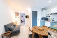 a living room and kitchen with a table and a couch at Nid douillet entre Paris et Disney in Vaires-sur-Marne