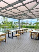 a patio with tables and chairs on a deck at At Pream&Chan resort แอท เปรมแอนด์จันทร์ รีสอร์ท in Ban Krasang